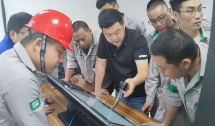 Students learning MySQL and Java programming at an educational workshop, focusing on hands-on technical skills and collaborative learning in a classroom setting.