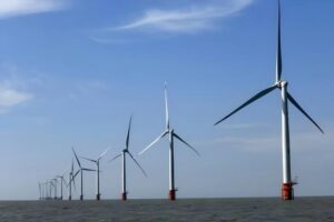 Offshore wind turbines installed in the ocean to harness wind energy for sustainable power production, contributing to clean energy initiatives and reducing carbon emissions.