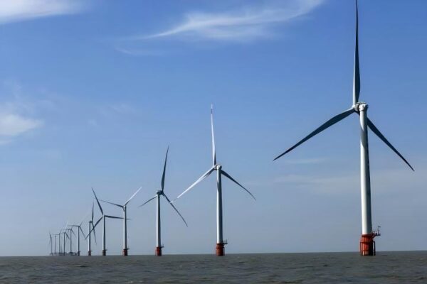 Offshore wind turbines installed in the ocean to harness wind energy for sustainable power production, contributing to clean energy initiatives and reducing carbon emissions.