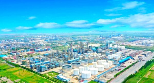 An aerial view of the CNOOC Dongying oil refinery showcasing extensive industrial infrastructure, storage tanks, and processing units, highlighting the scale and operational capacity of the project.