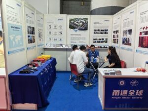 Ningbo Global Gateway booth at trade show showcasing telecommunications and technology solutions with display tables and informational posters.