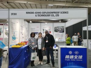 Exhibition booth of Ningbo Joiwo Explosionproof Science & Technology Co., Ltd at a trade show, showcasing safety and explosion-proof equipment with visitors engaging.