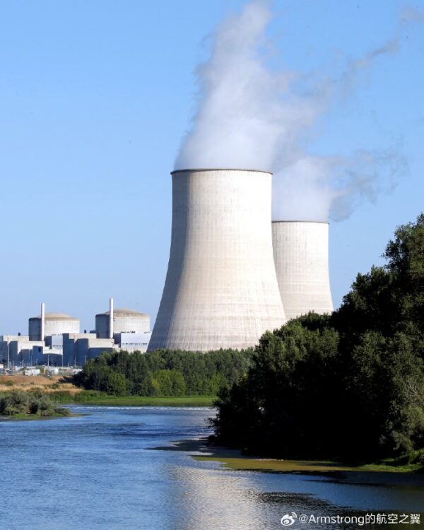 Cooling towers emitting steam at a nuclear power plant.