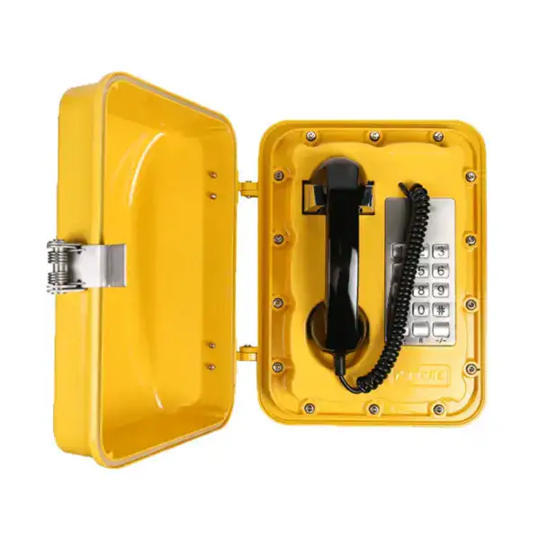 Industrial waterproof telephone with keypad and handset, designed for mining environments, housed in a durable yellow protective case.