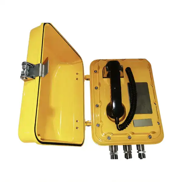 Bright yellow emergency telephone box with handset, digital display, and multiple connection ports, designed for safety and communication in critical situations.