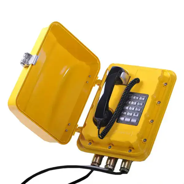 Explosion proof emergency telephone with loudspeaker, rugged yellow housing, keypad, and handset for hazardous environments.