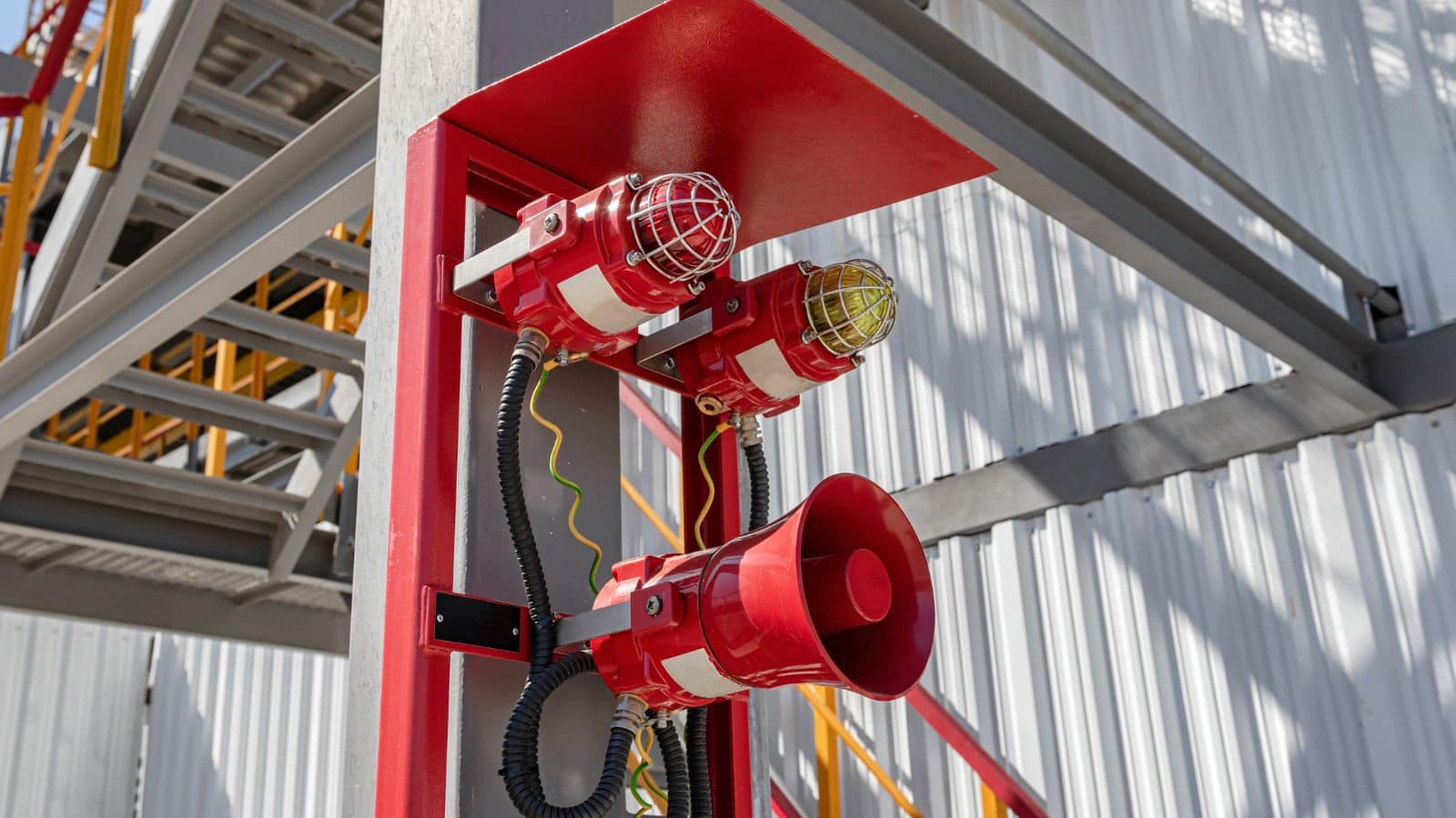 a paga system speaker with flashing beacon installed in a factory